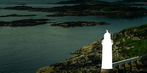 White lighthouse in front of the sea