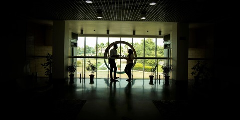 Two employees have a conversation in the foyer